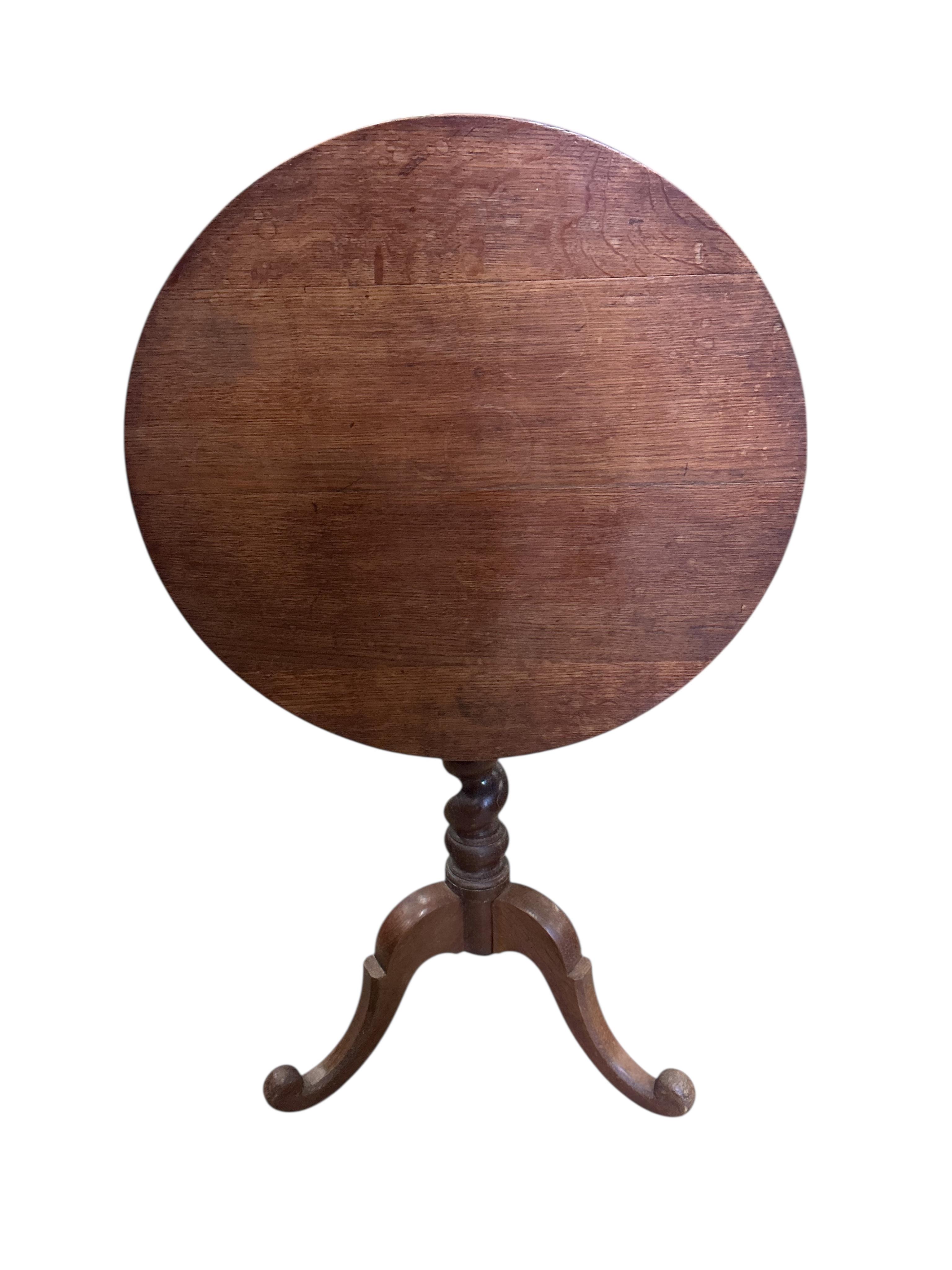 A 19th century circular oak tilt top tripod wine table, diameter 60cm, height 72cm